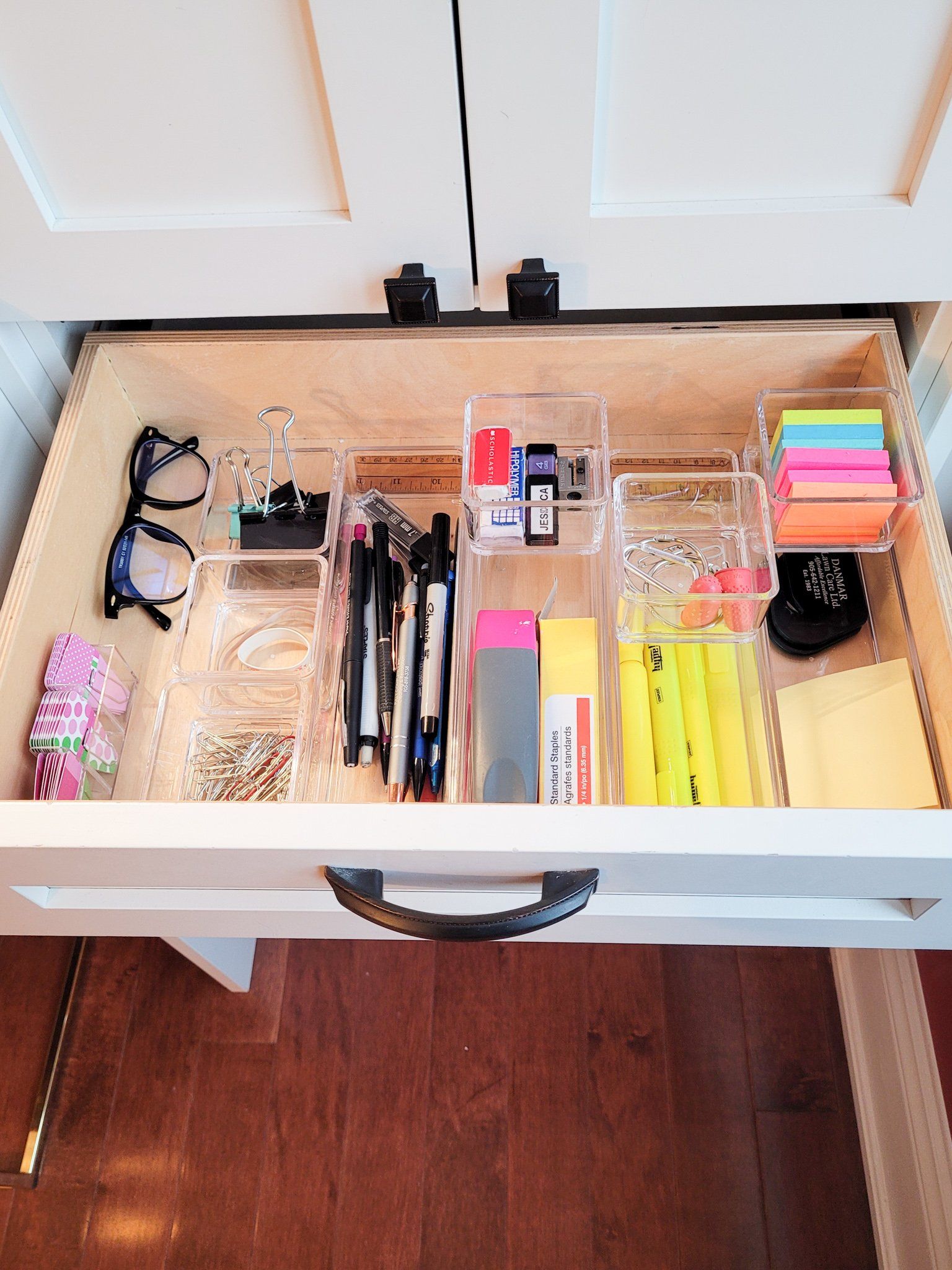 A drawer filled with a variety of office supplies