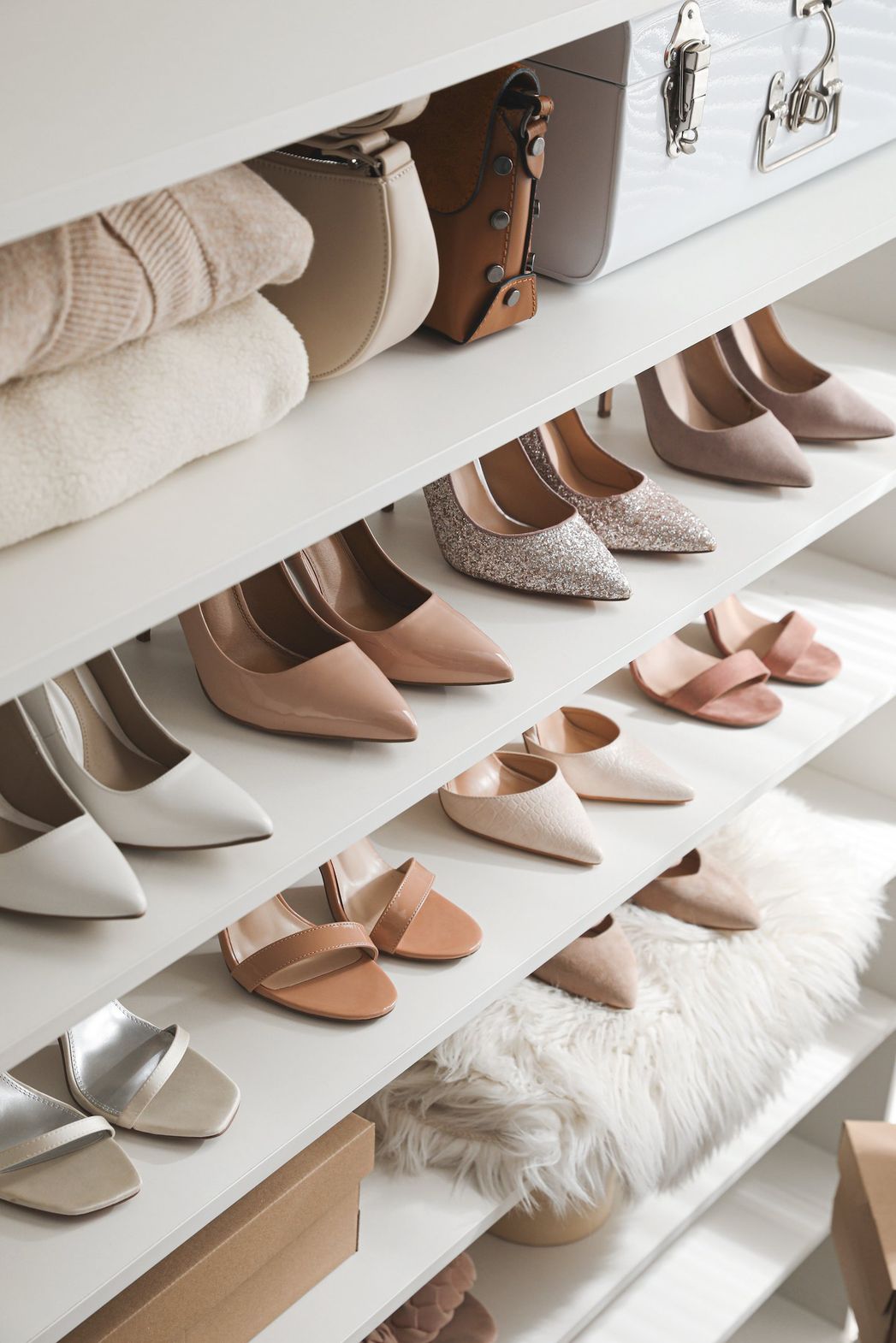 A closet filled with lots of shoes and clothes.