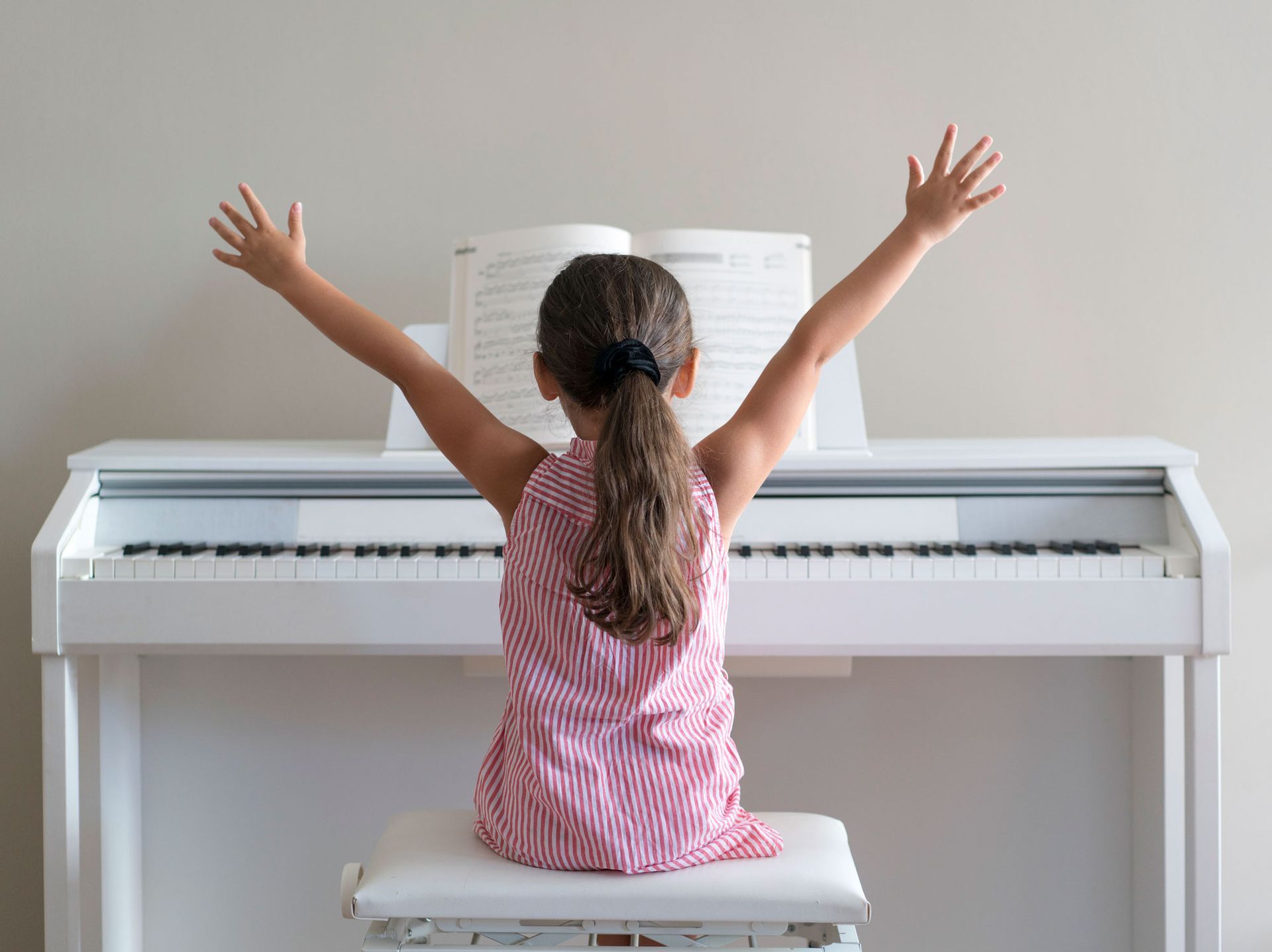 A Kid With Her Arms Outstretched | Clayton, NC | Neighborhood Academy of Music