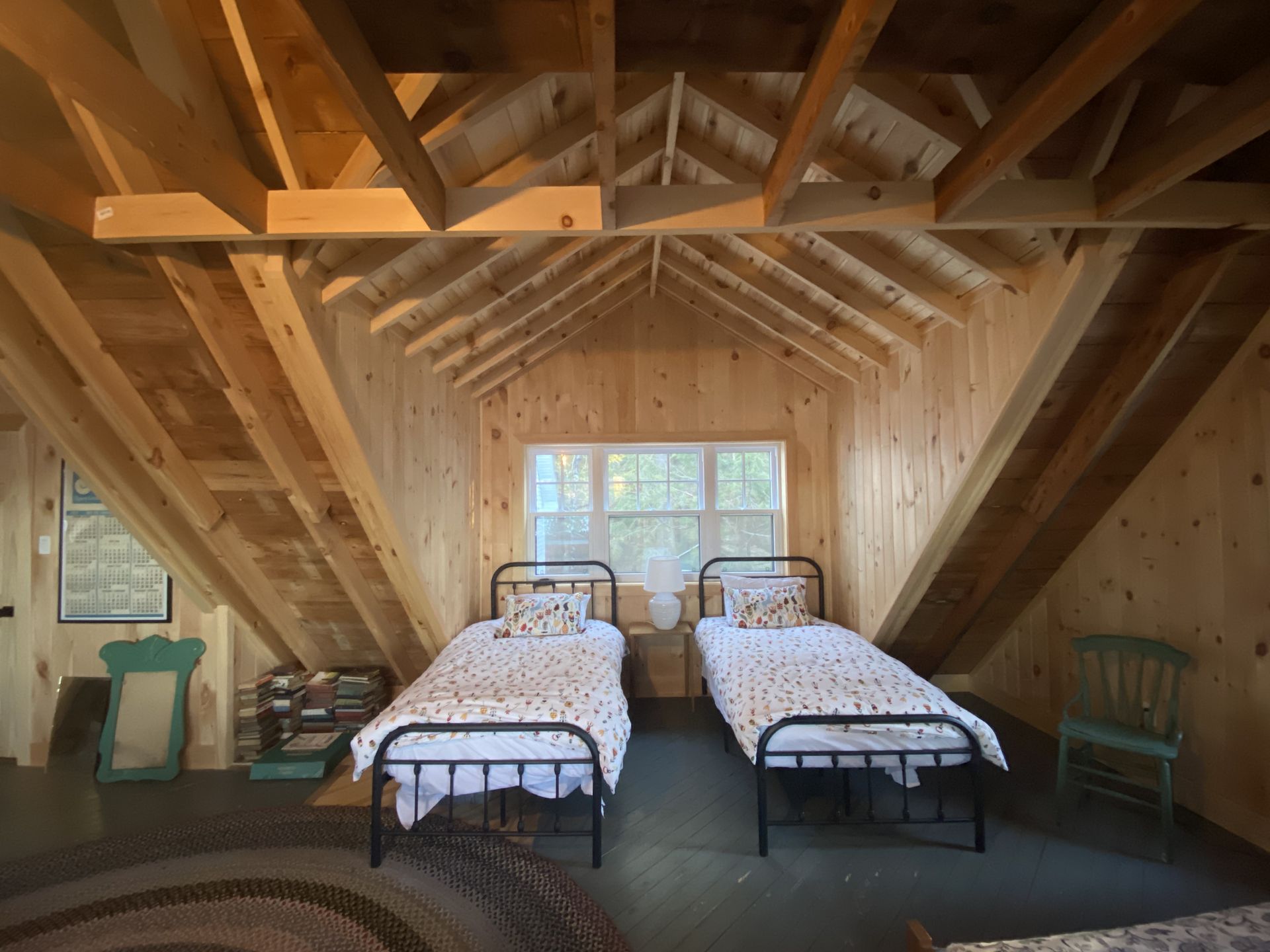 A bedroom with two twin beds and a chair