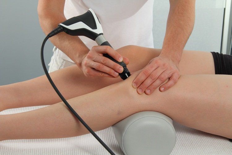 A person is receiving a shockwave therapy treatment in Wandsworth, London