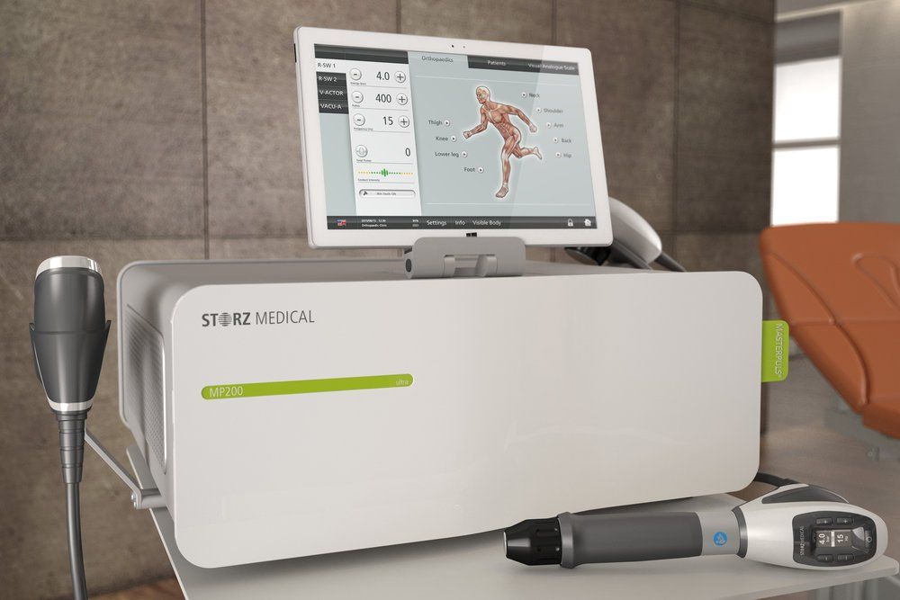 A medical shockwave therapy device with a monitor on top of it