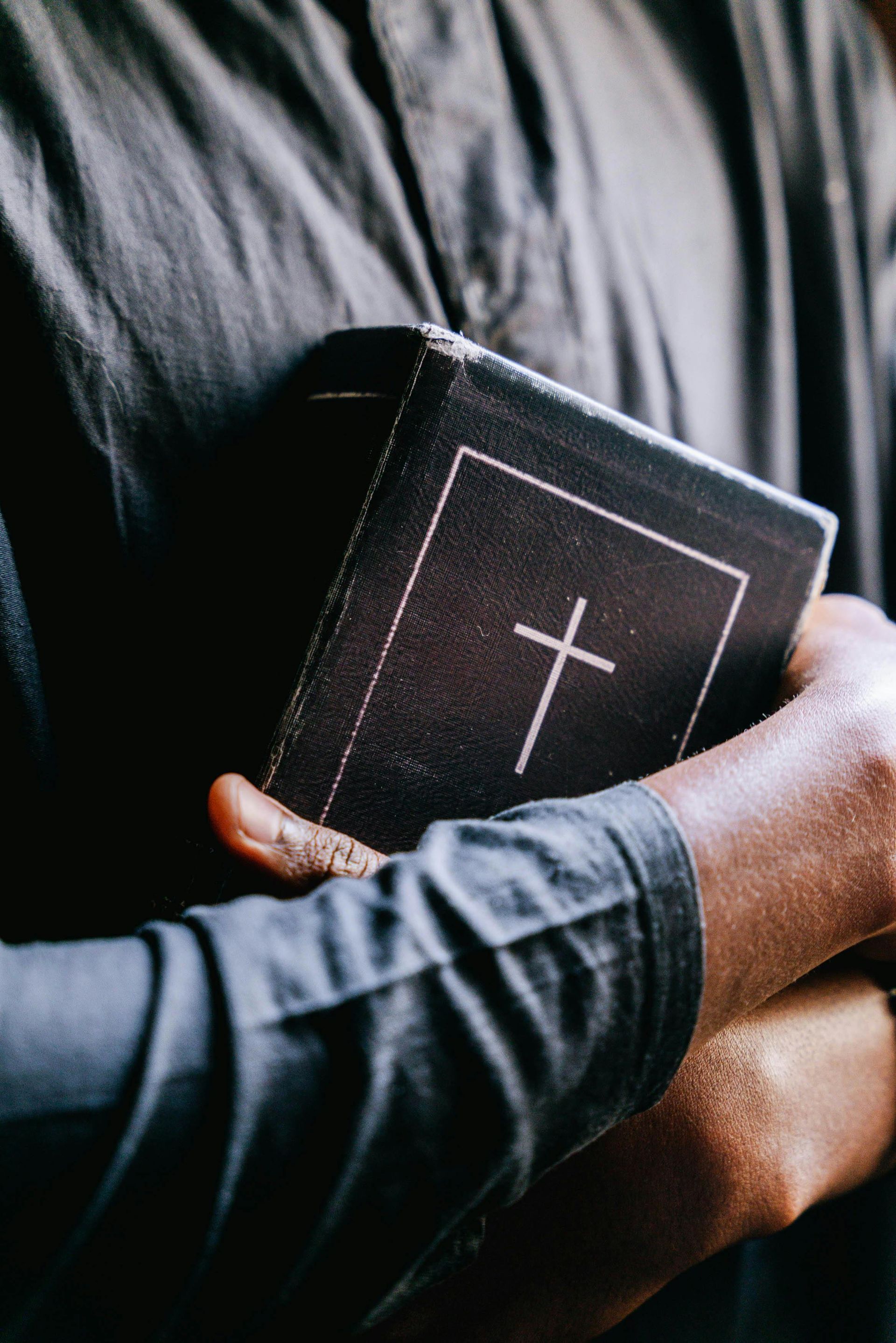 An open Bible on a wooden table representing faithful preaching