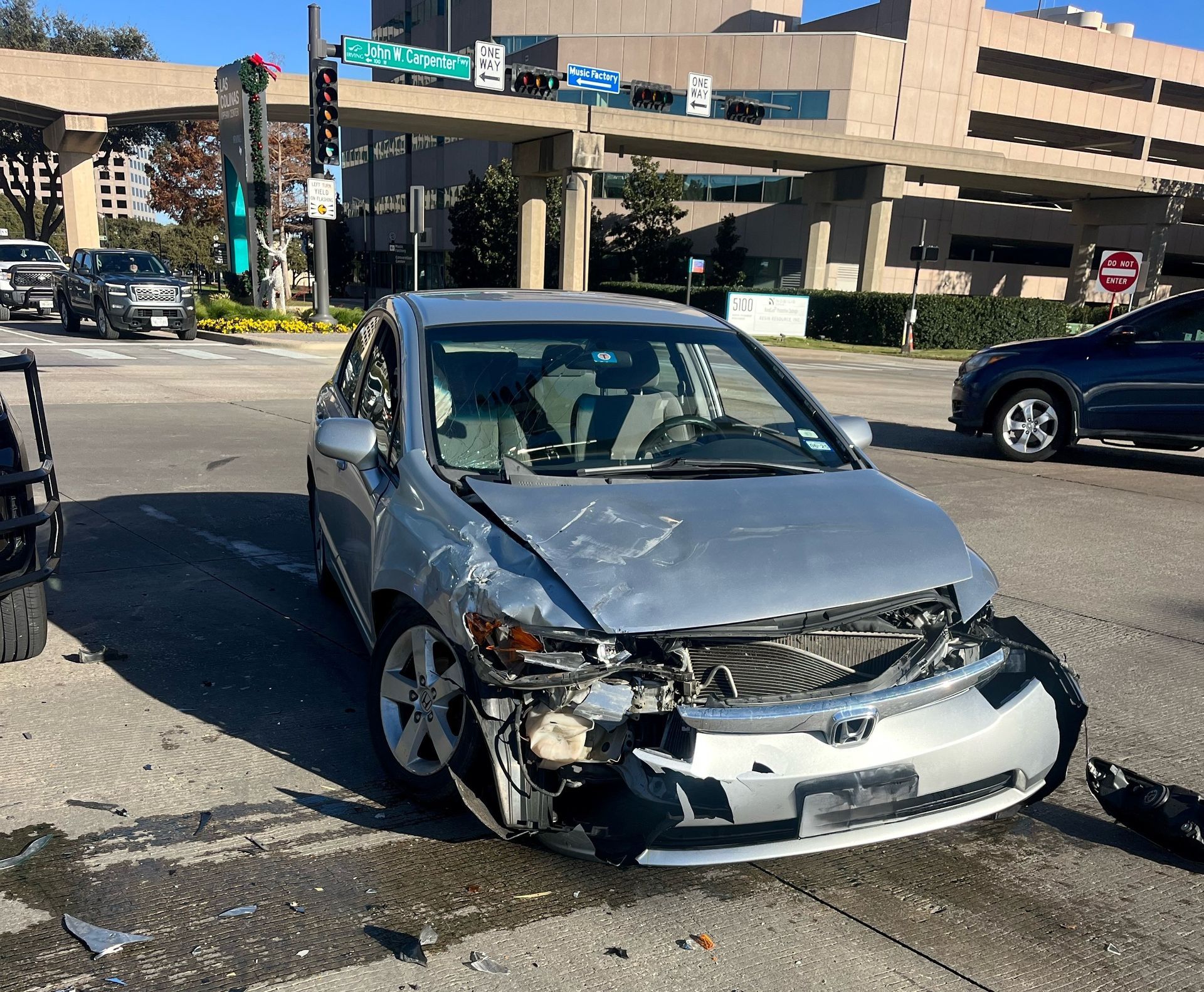 Front-passenger side of a silver sedan is smashed after a car crash in Irving.