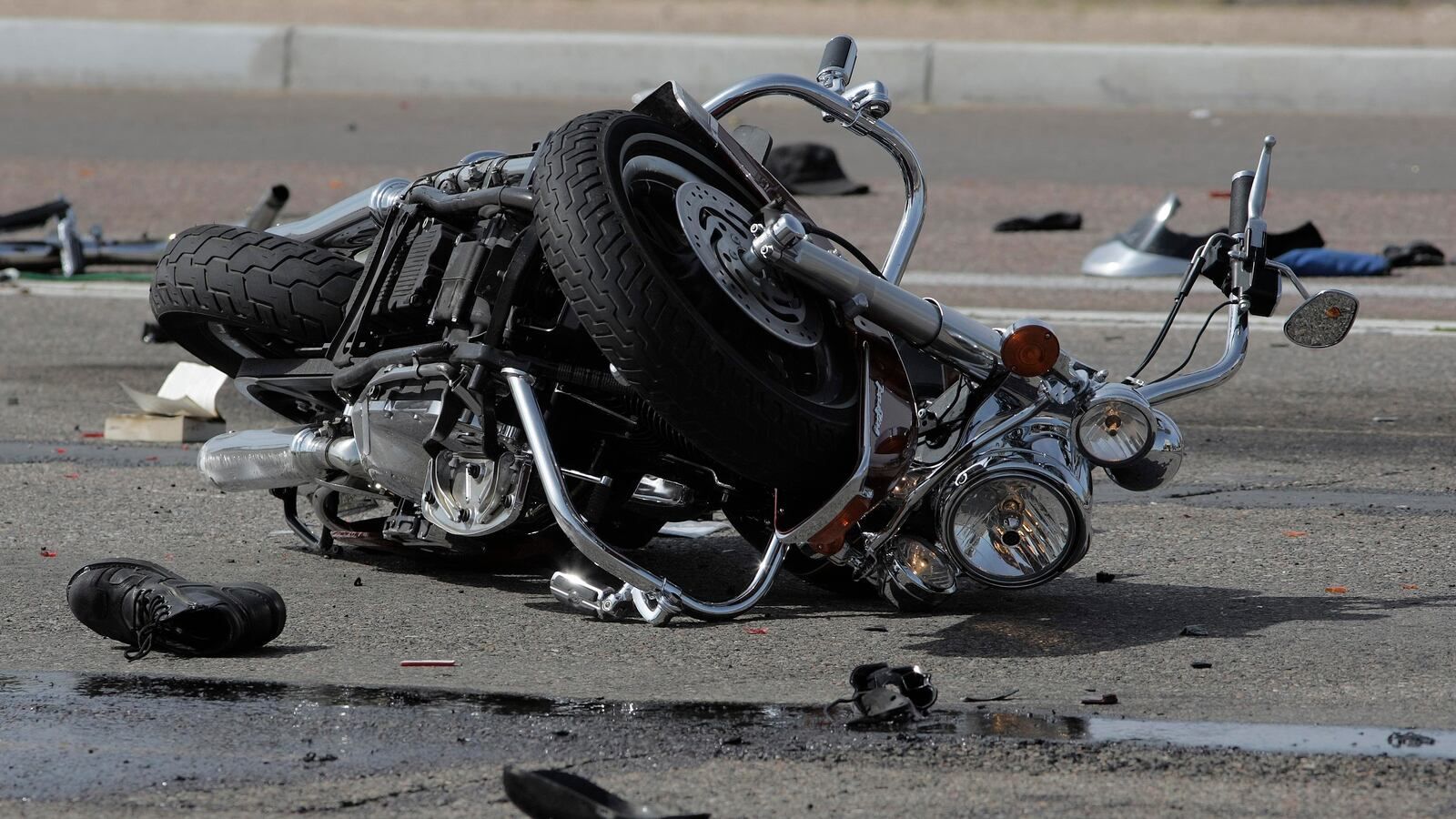A motorcycle has crashed on the side of the road.