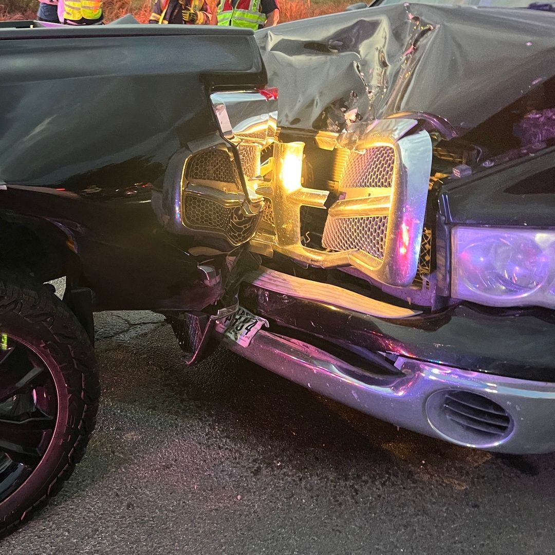 Close up of two crumpled vehicles caused by a rear-end collision at a red light in Denton, Texas.