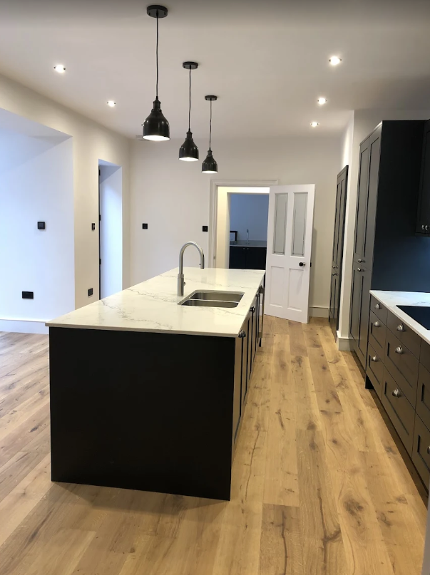 A kitchen painted white by Elite Edge Painters and Decorators Manchester