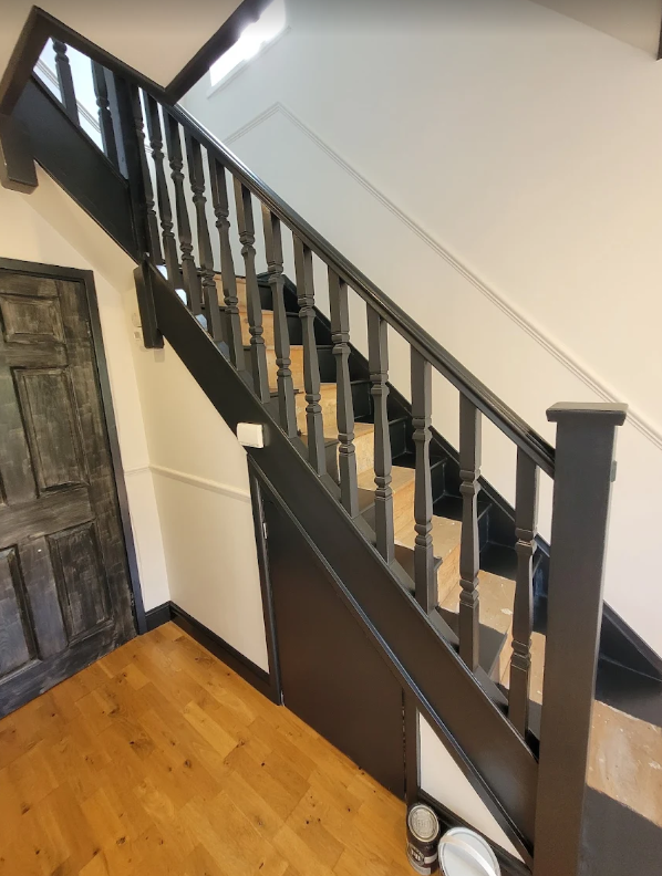 A picture of a staircase painted in black and white by Elite Edge Painters and Decorators Manchester