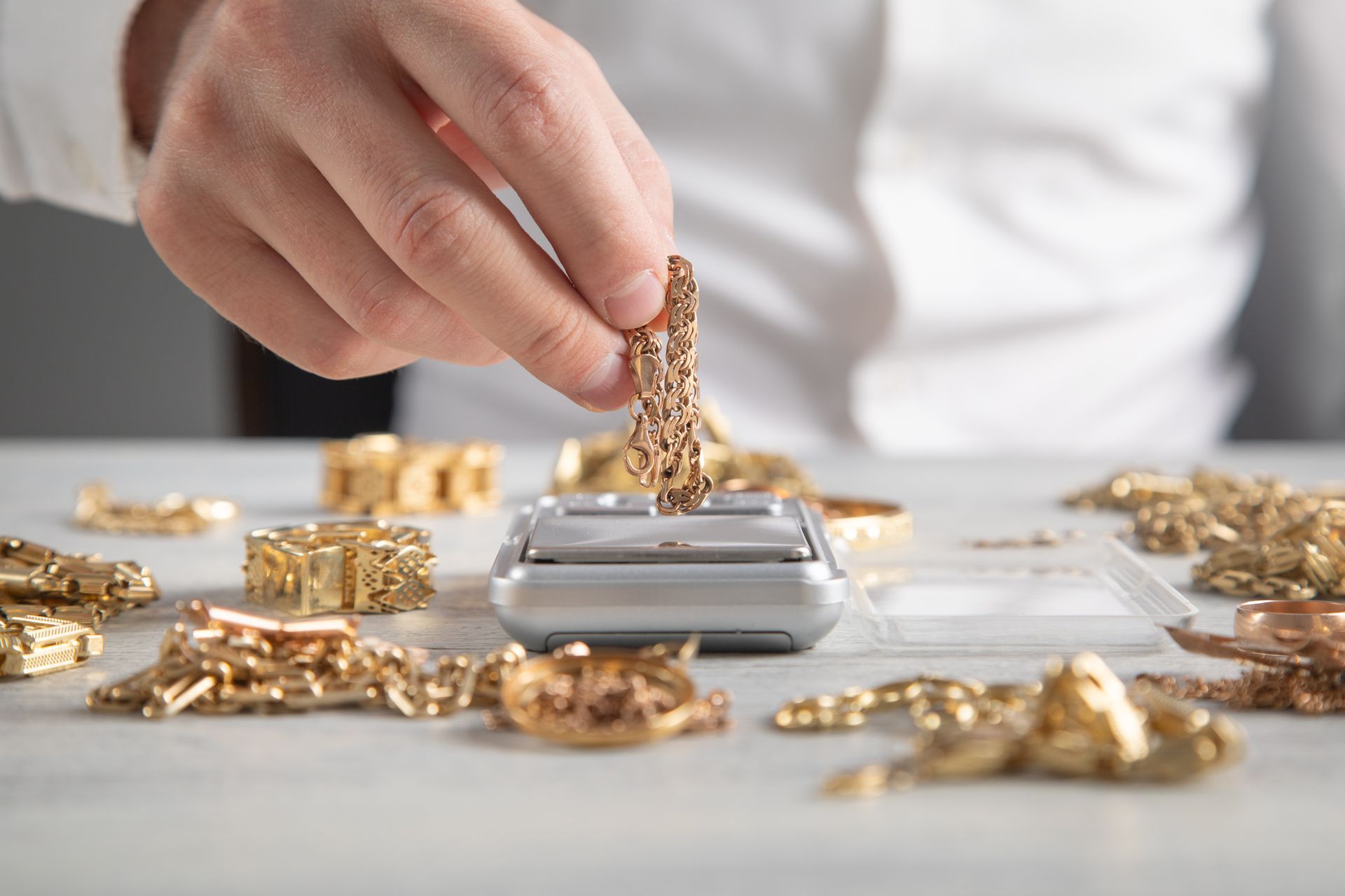 Gold buyer with a digital scale and gold