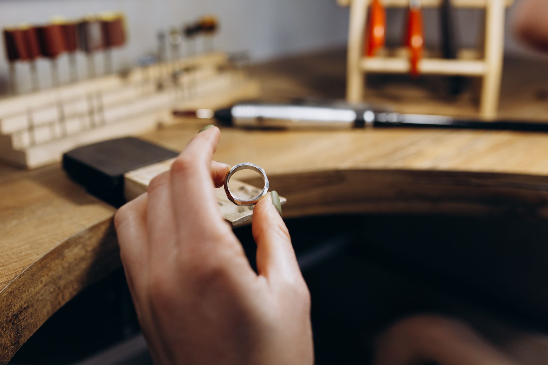 Hand holding silver ring