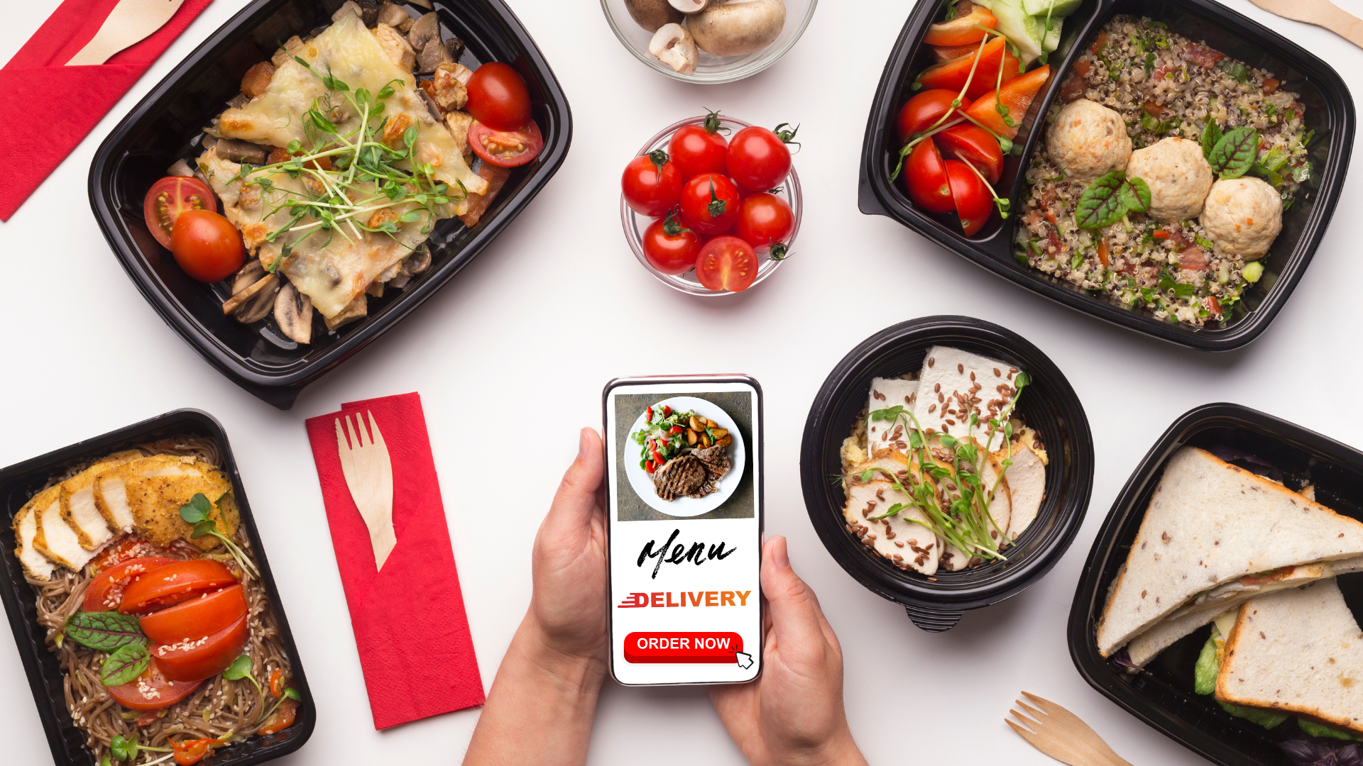 Hands hold a smartphone displaying a food delivery app, surrounded by various healthy takeout meals on a white surface.