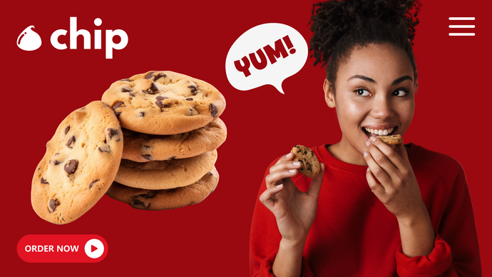 A person in a red sweater eats a cookie next to a stack of cookies on a red background with a