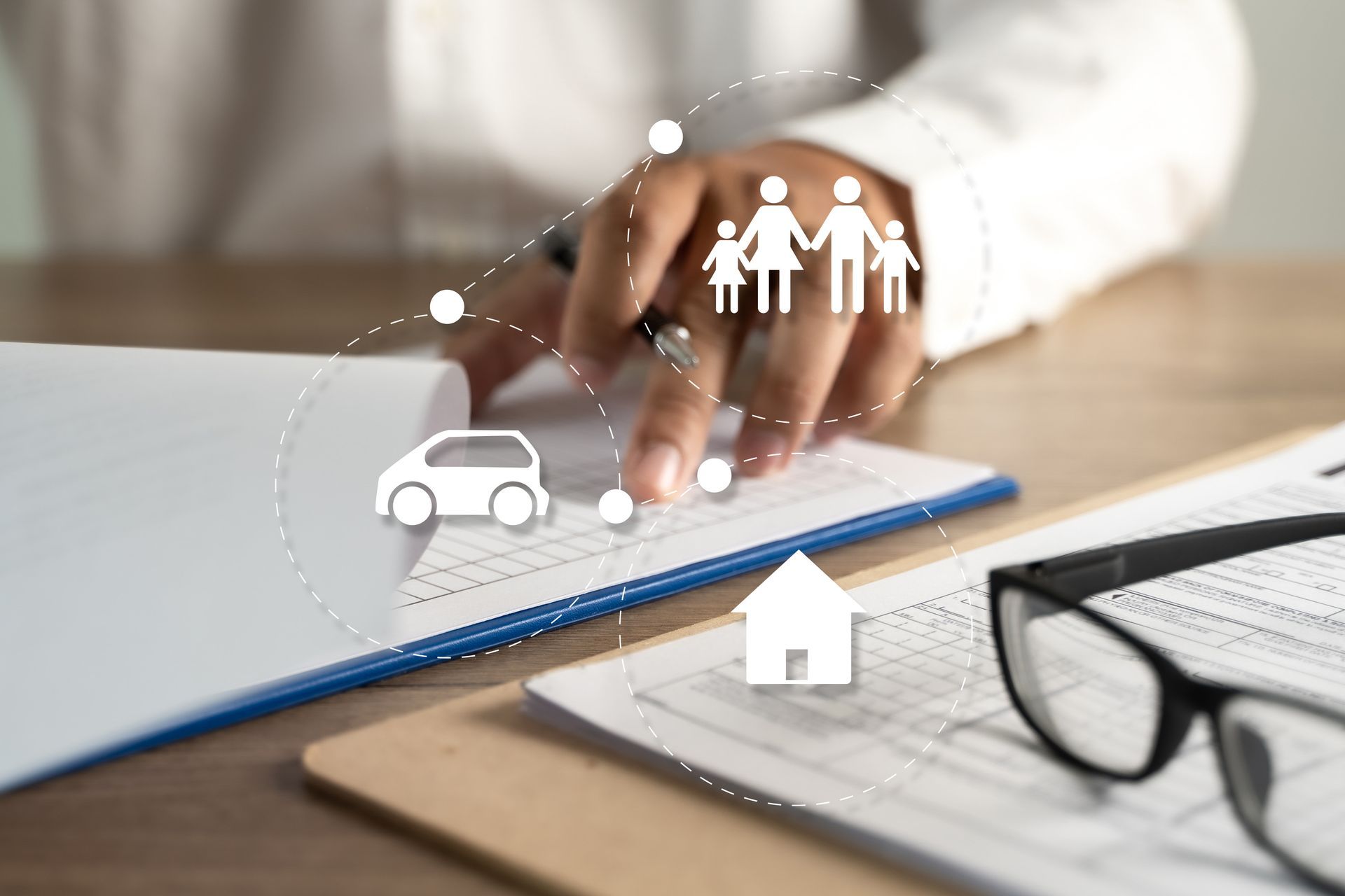 Person reviewing paperwork with icons of family, car, and house, symbolizing insurance.