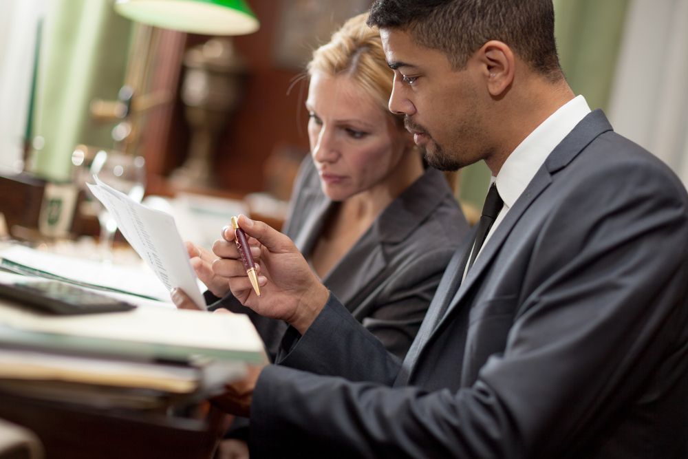 Lawyer and Client Are Looking at a Piece of Paper — O'Reilly & Sochacki Lawyers in Murwillumbah, NSW