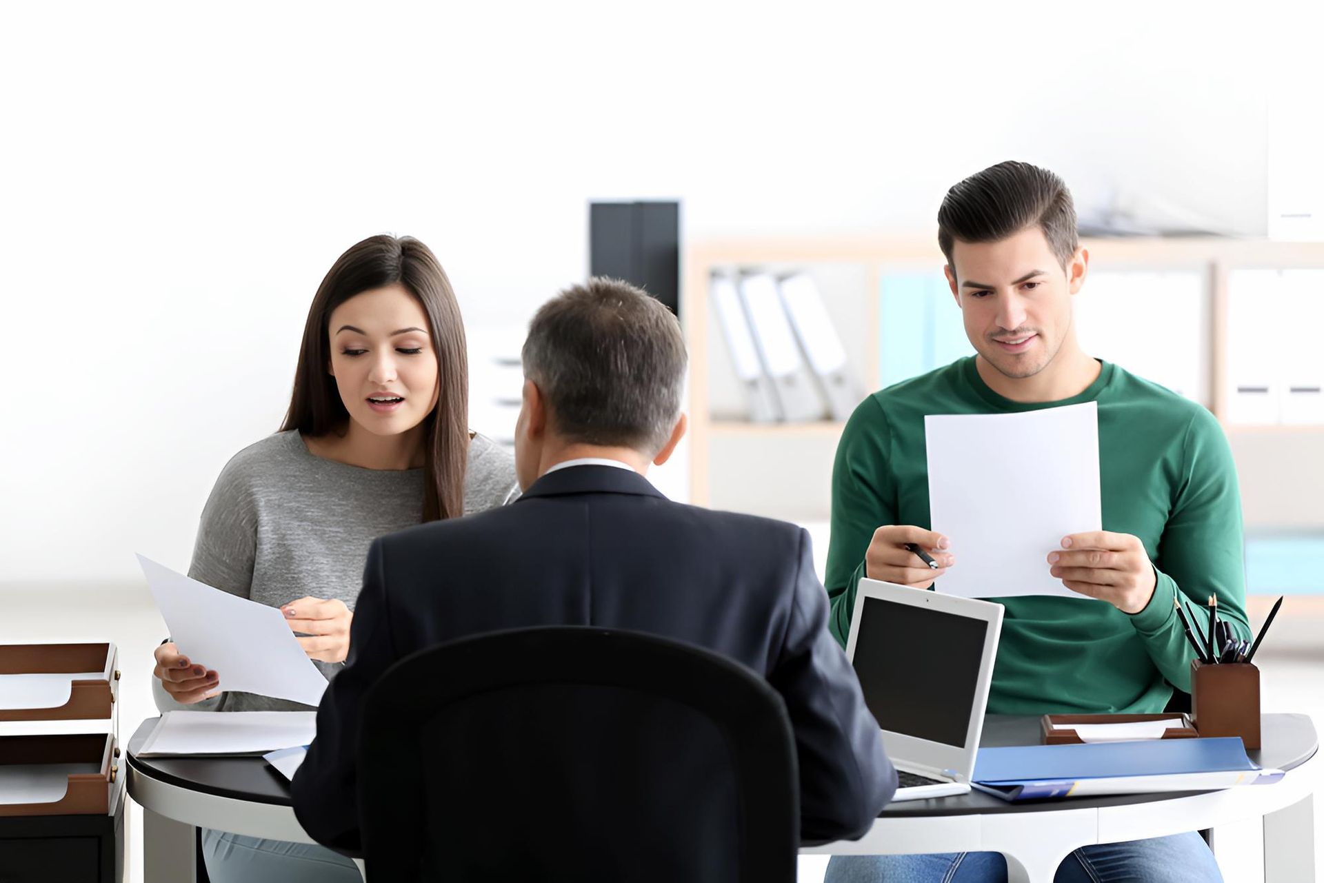 A Man is Taking at a Table With a Client — O'Reilly & Sochacki Lawyers in Tweed Heads, NSW