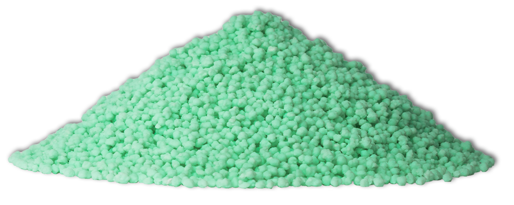 A pile of green powder is sitting on top of a white surface.