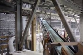 A conveyor belt is moving through a factory.