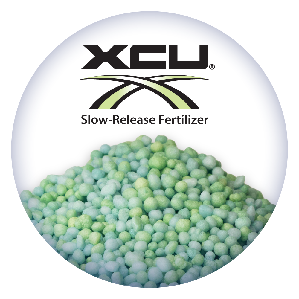 A pile of green xcu slow release fertilizer