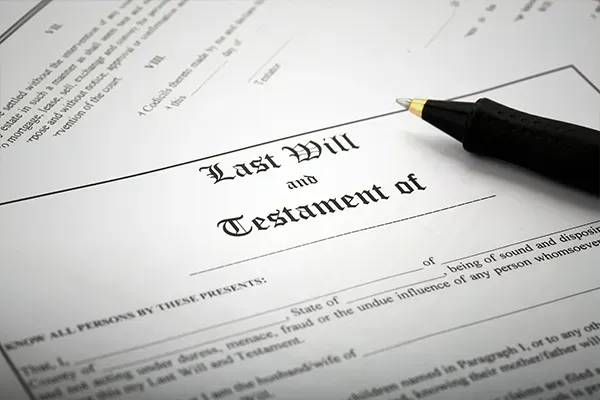 Last will and testament document with a pen resting on it