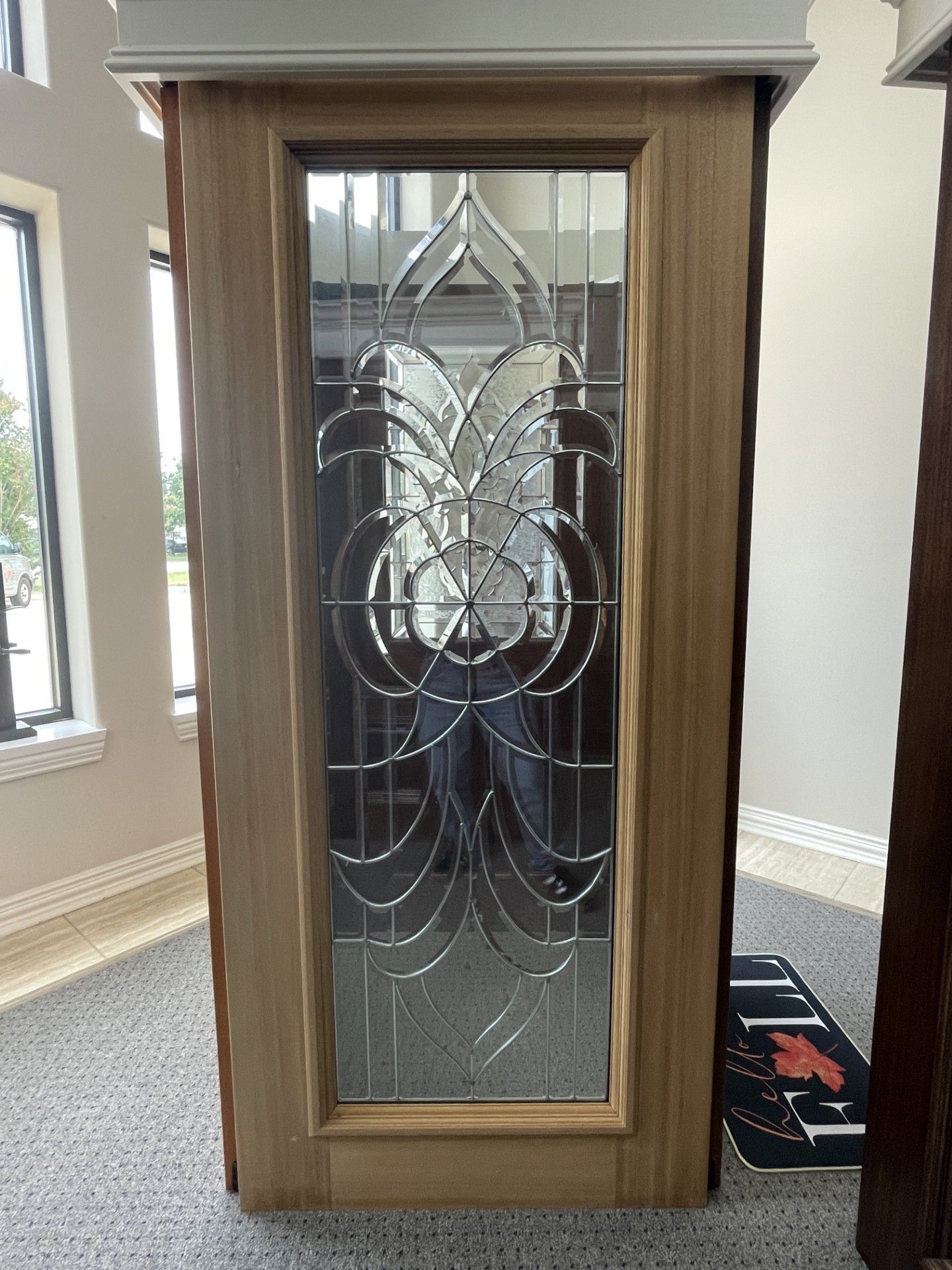 Wooden-framed decorative glass door with etched floral pattern in a hallway room