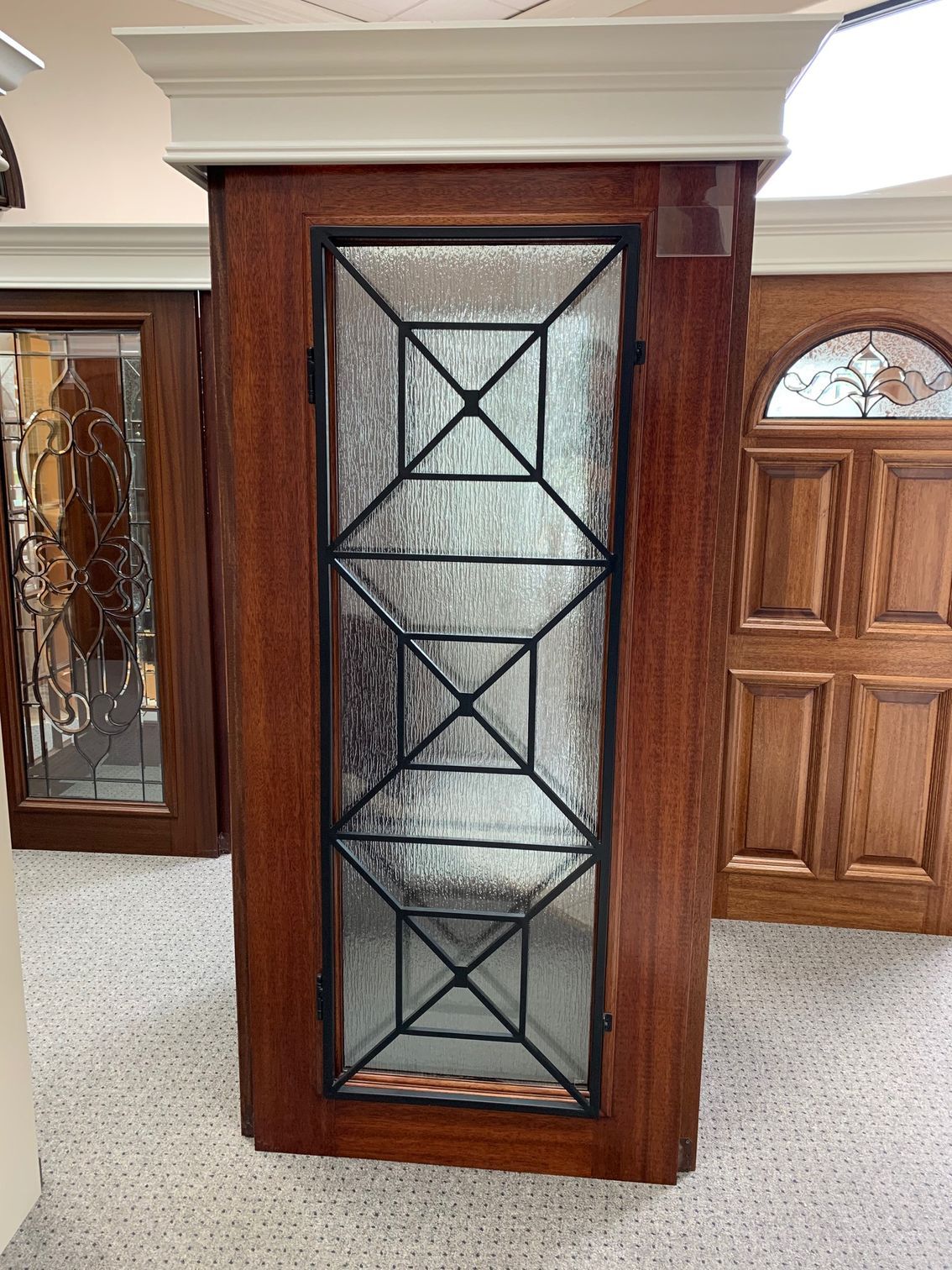 Wooden cabinet with leaded glass doors in a furniture showroom