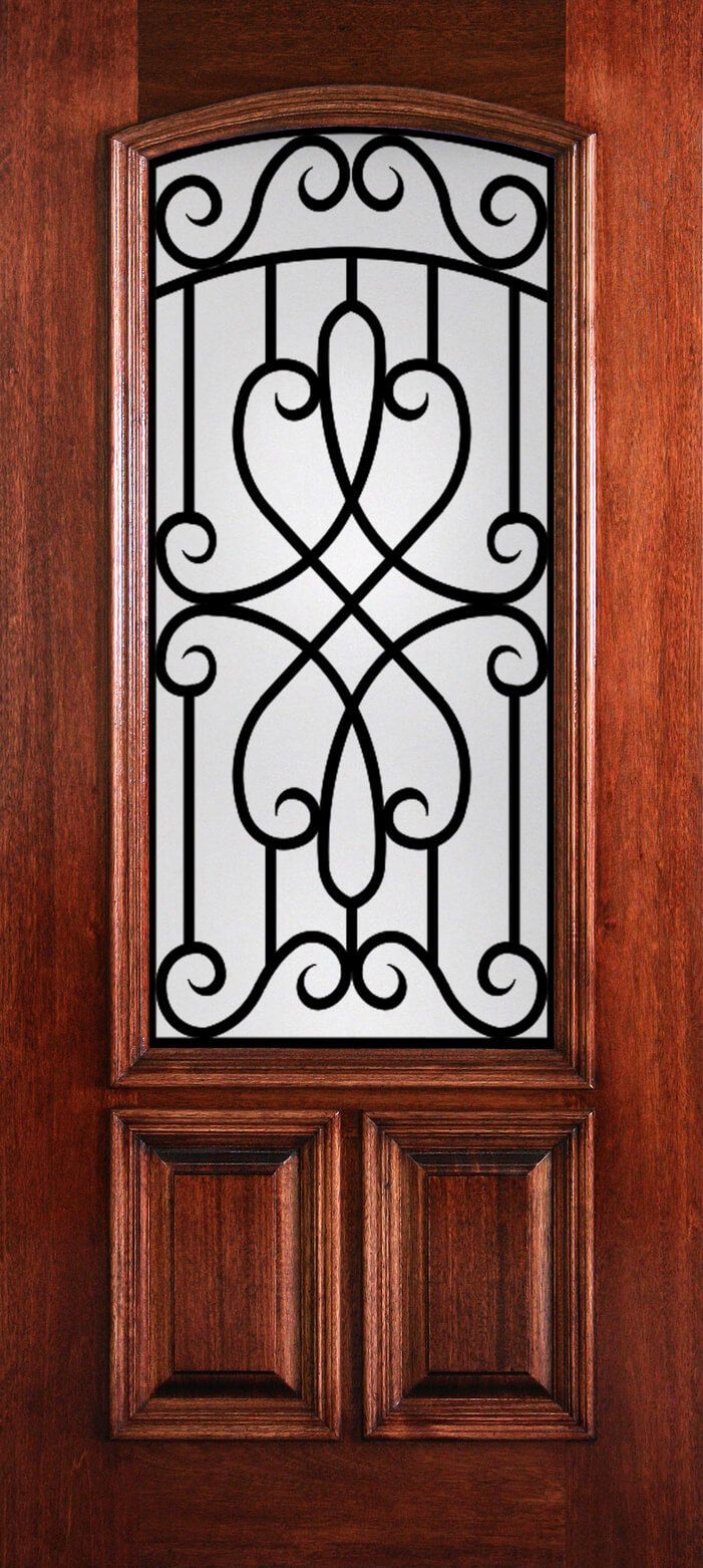 Wooden front door with a frosted glass panel and ornate black metal scrollwork.