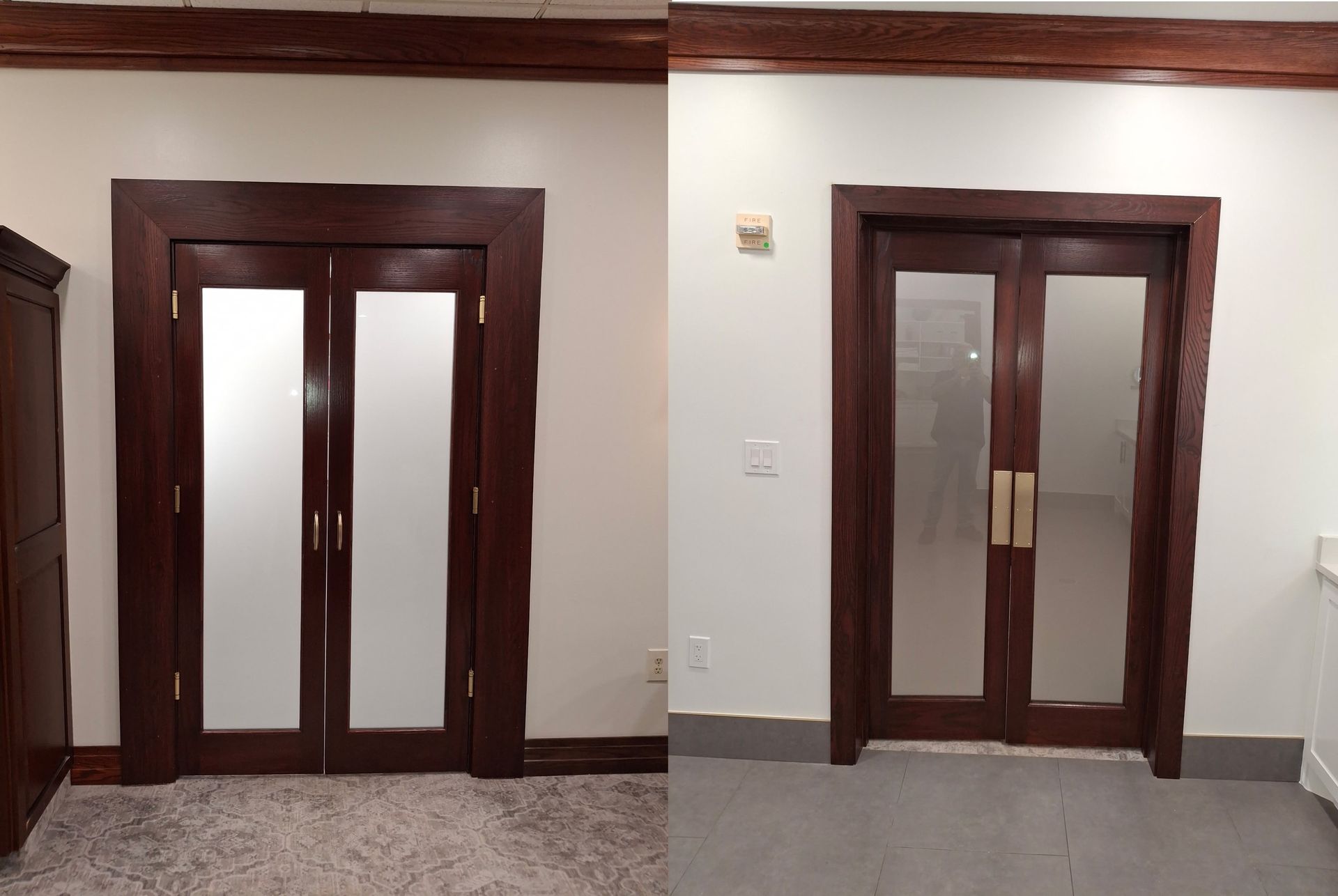 Two dark wood double doors with frosted glass panels in a white hallway