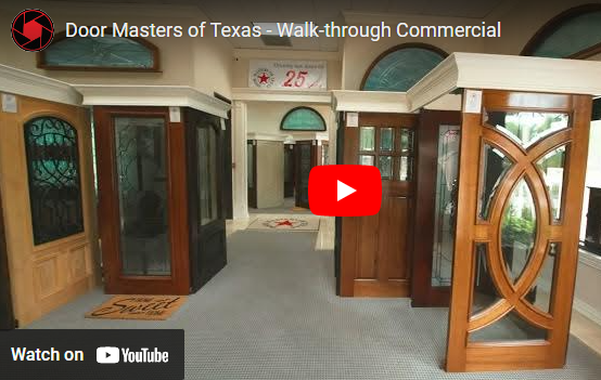 Showroom with several decorative wooden doors on display, including a curved double door and stained glass door.