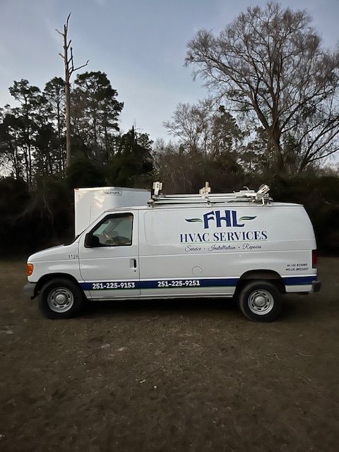 White FHL HVAC Services van parked outdoors at dusk with trees in the background