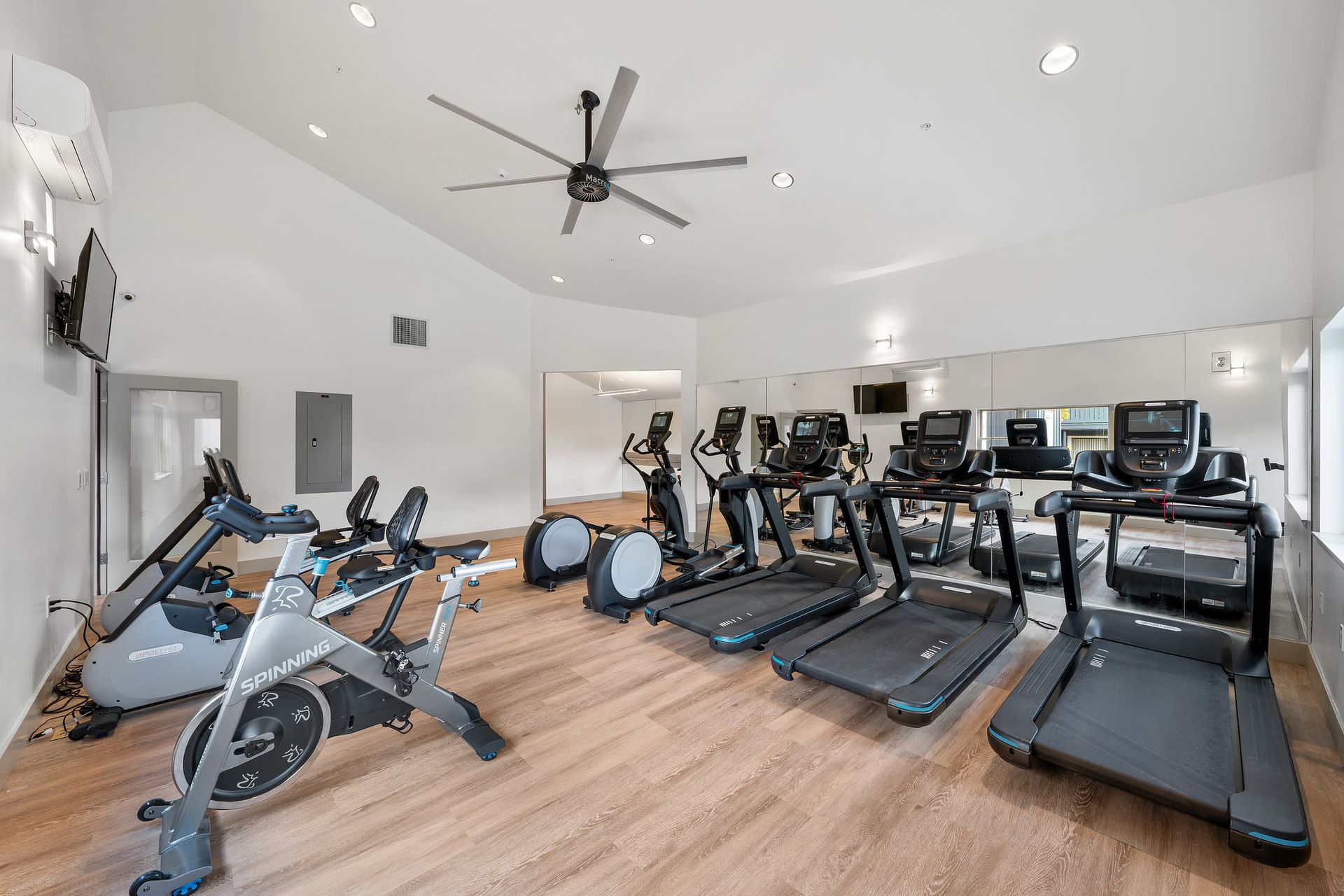 Fitness center with treadmills, stationary bikes, and ellipticals at Ballena Village apartments in Alameda, CA.