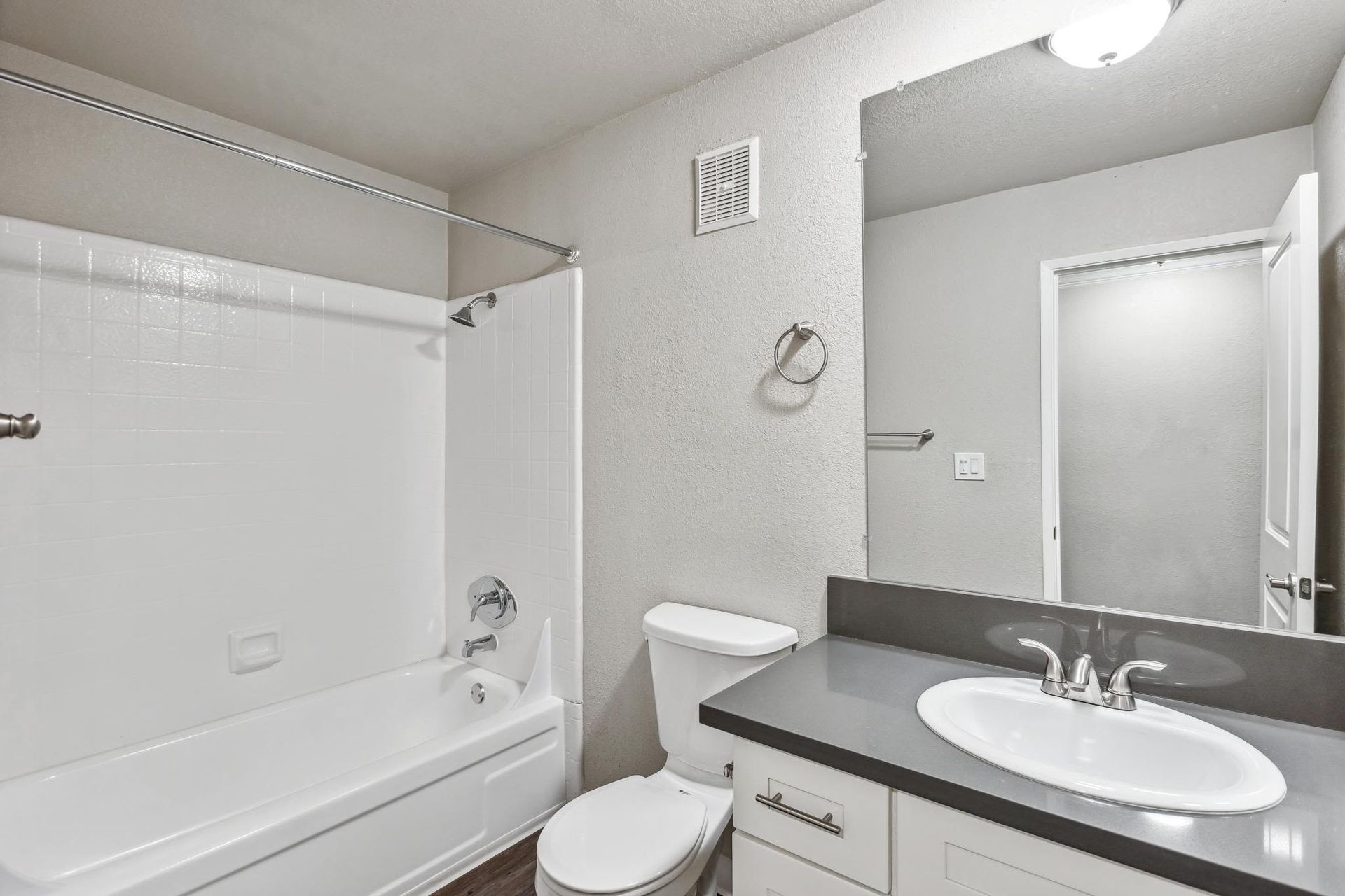 Bathroom in an apartment with a shower/tub combo, toilet, and vanity at Ballena Village apartments in Alameda, CA.