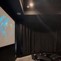 There is a projector screen in the middle of the room.
