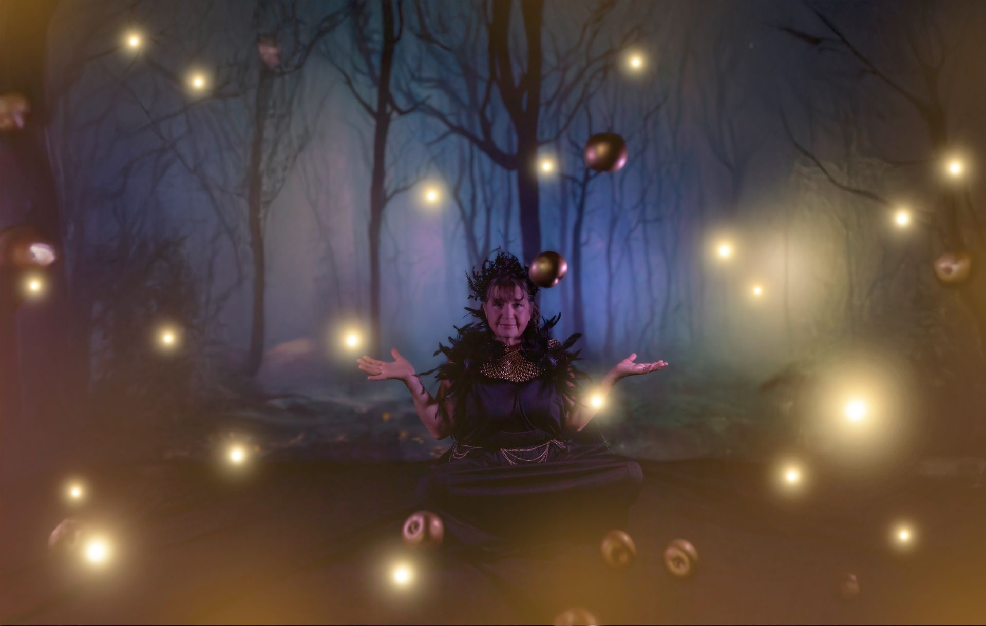 A performer juggles glowing orbs in a mystical forest. They have dark attire and a theatrical expression.