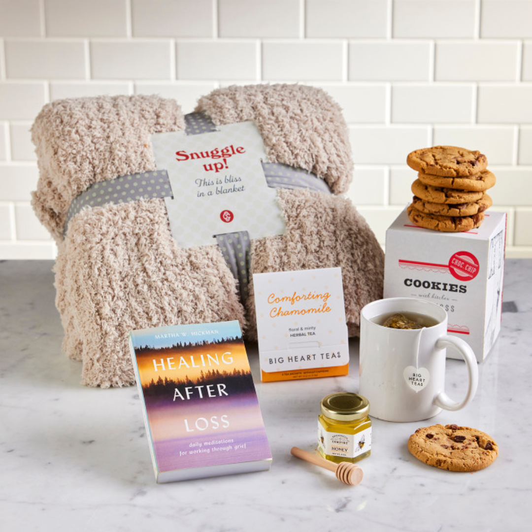 A blanket with a book titled healing after loss on it