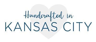 A handcrafted in kansas city logo with a heart in the background.