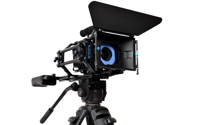A video camera is sitting on top of a tripod on a white background.