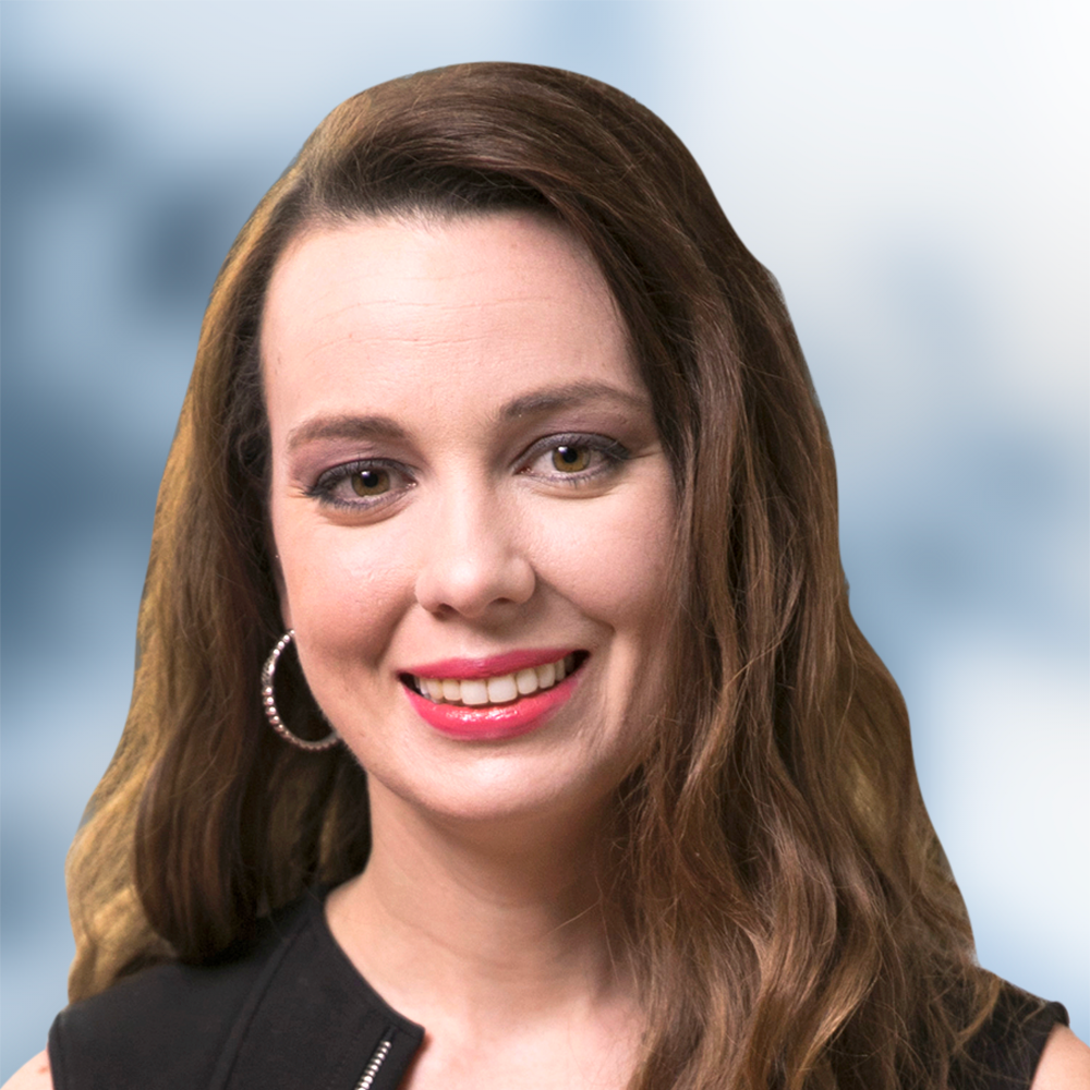 A woman wearing hoop earrings is smiling for the camera