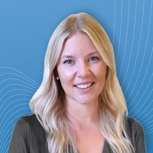 A woman with blonde hair is smiling in front of a blue background.