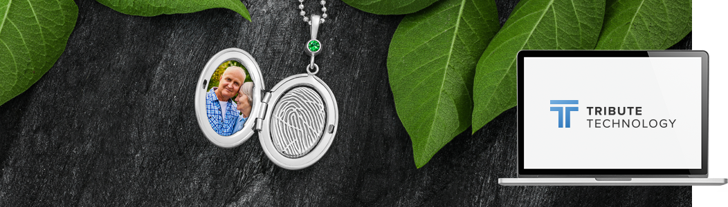 A locket with a picture of a child on it is sitting on a table next to a laptop.
