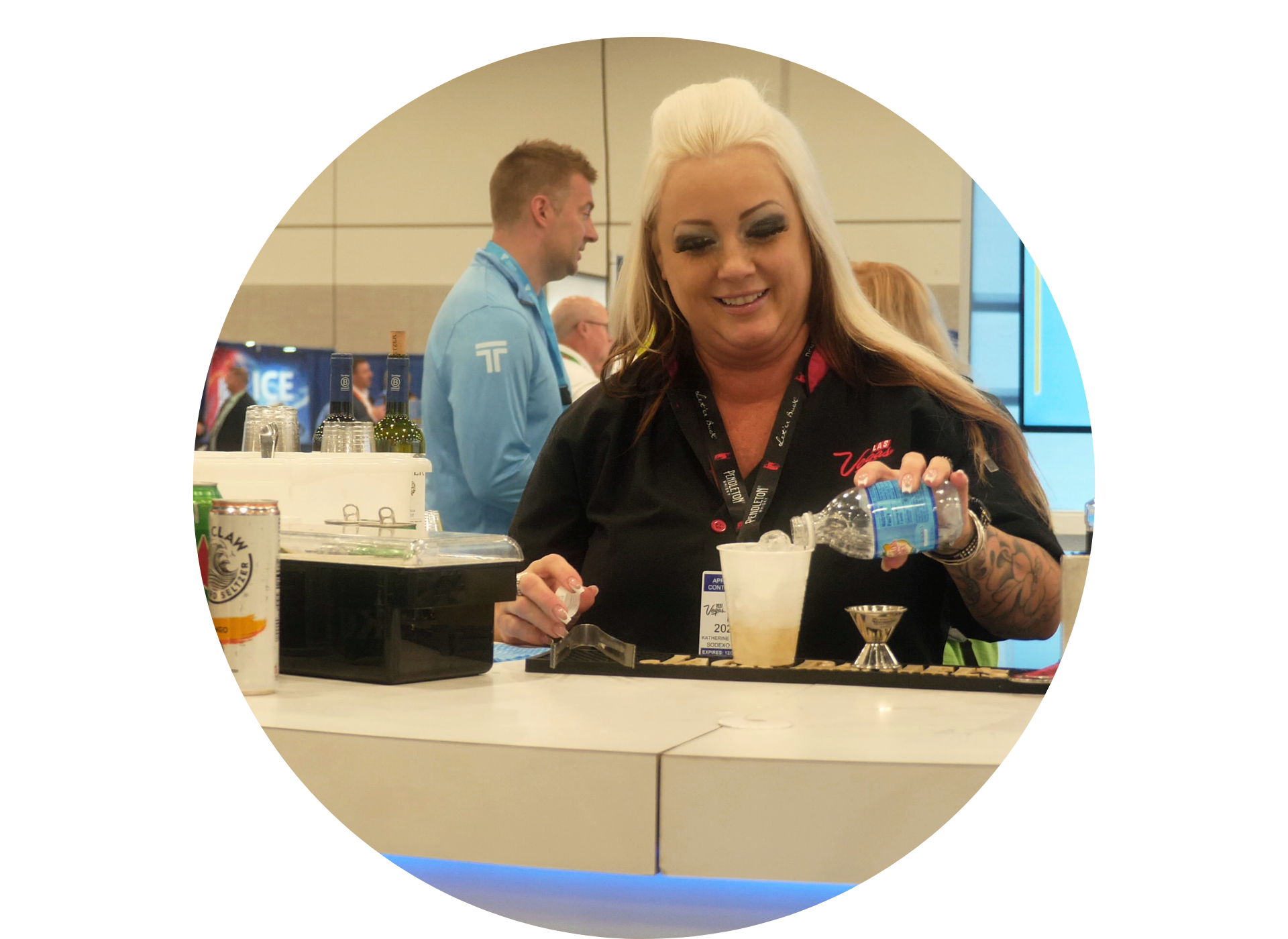 A woman is holding a bottle of water and pouring it into a glass.