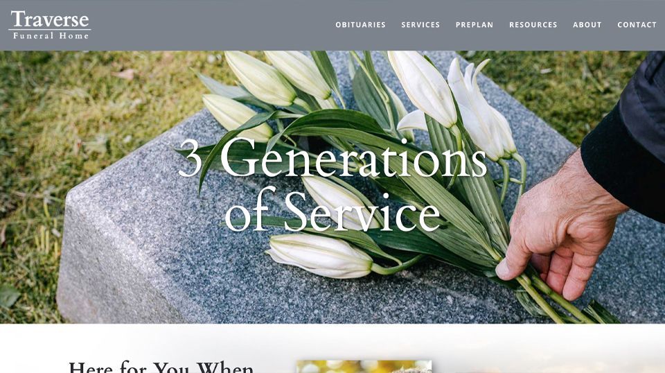 A website for traverse funeral home shows a person putting flowers on a grave.