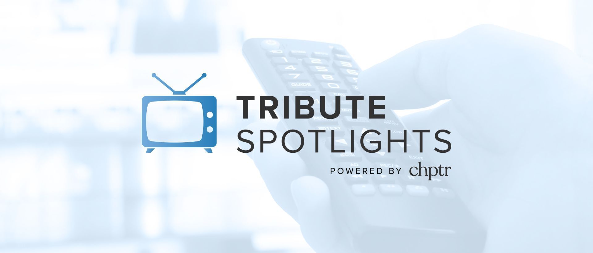 A person is holding a remote control in front of a tribute spotlights logo.