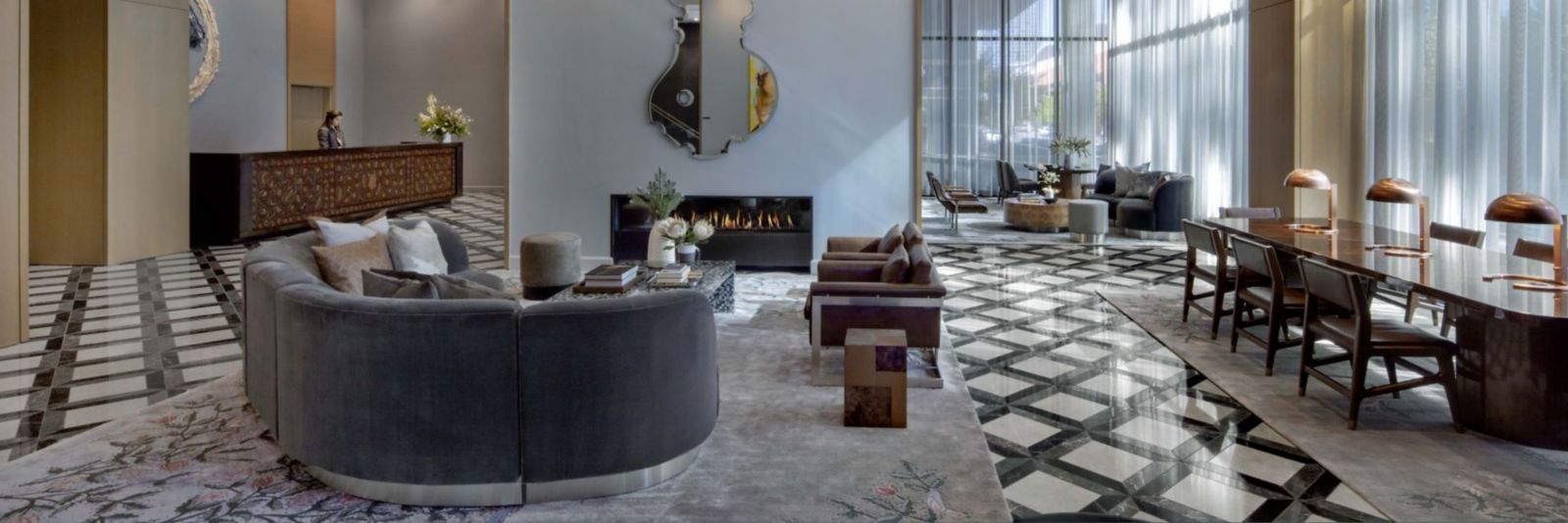 A living room with a couch , table , chairs and a fireplace.