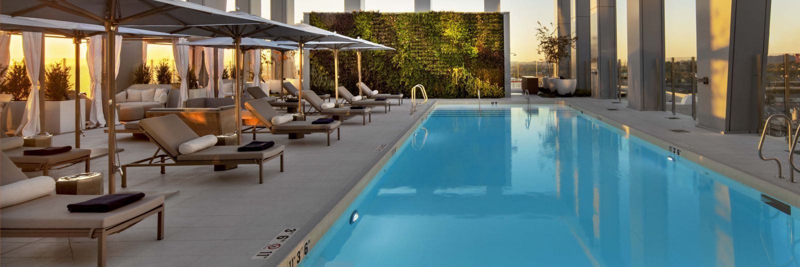 A large swimming pool with chairs and umbrellas around it