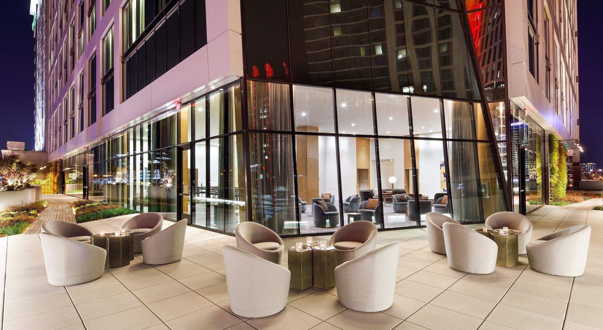 A large building with a lot of windows and chairs in front of it.