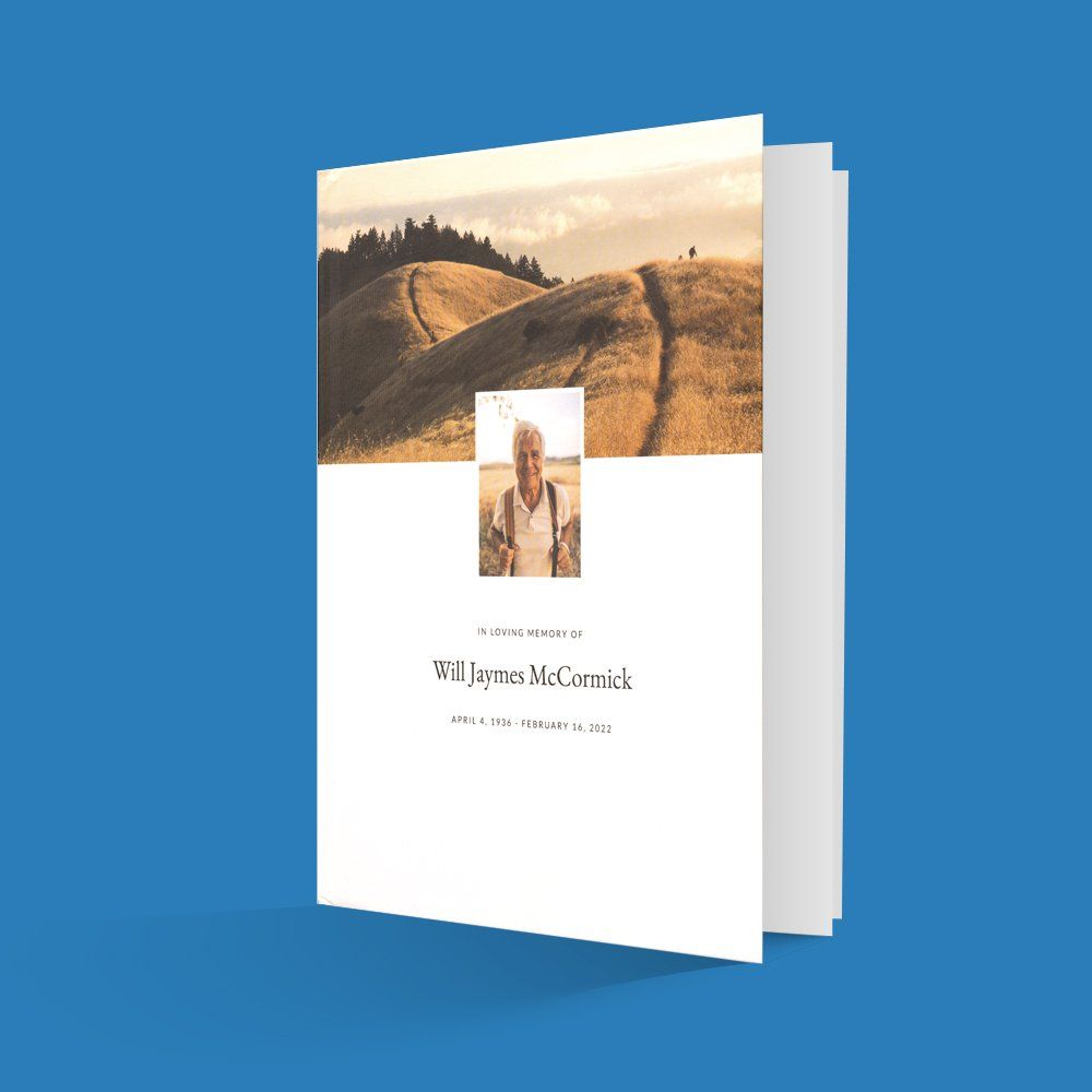 A book with a picture of a man standing on a hill.