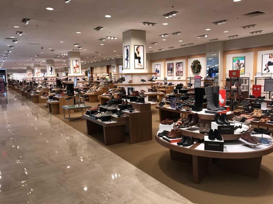A shoe store with a lot of shoes on display