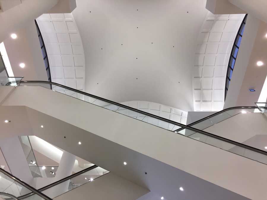 Looking up at the ceiling of an escalator in a building