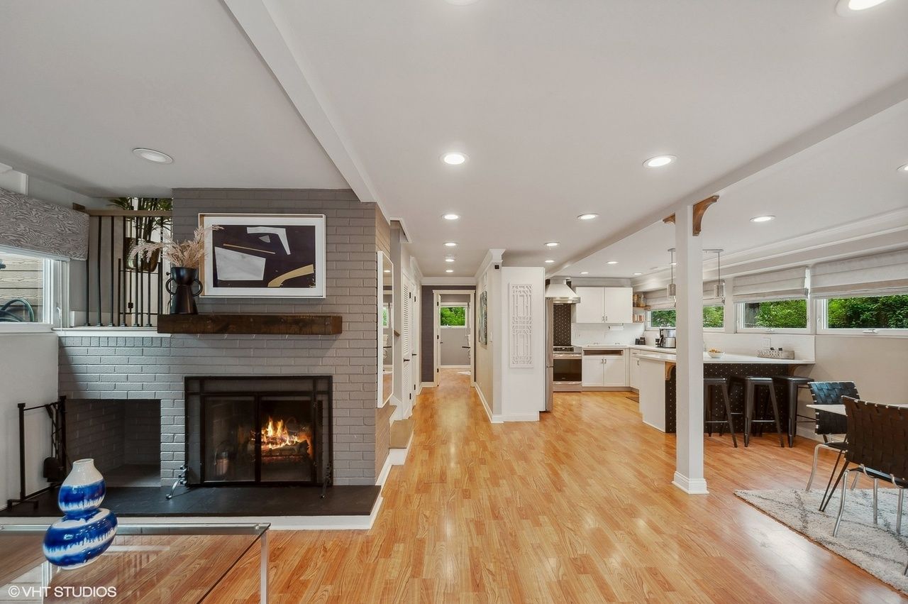 A living room with a fireplace and hardwood floors in north shore il