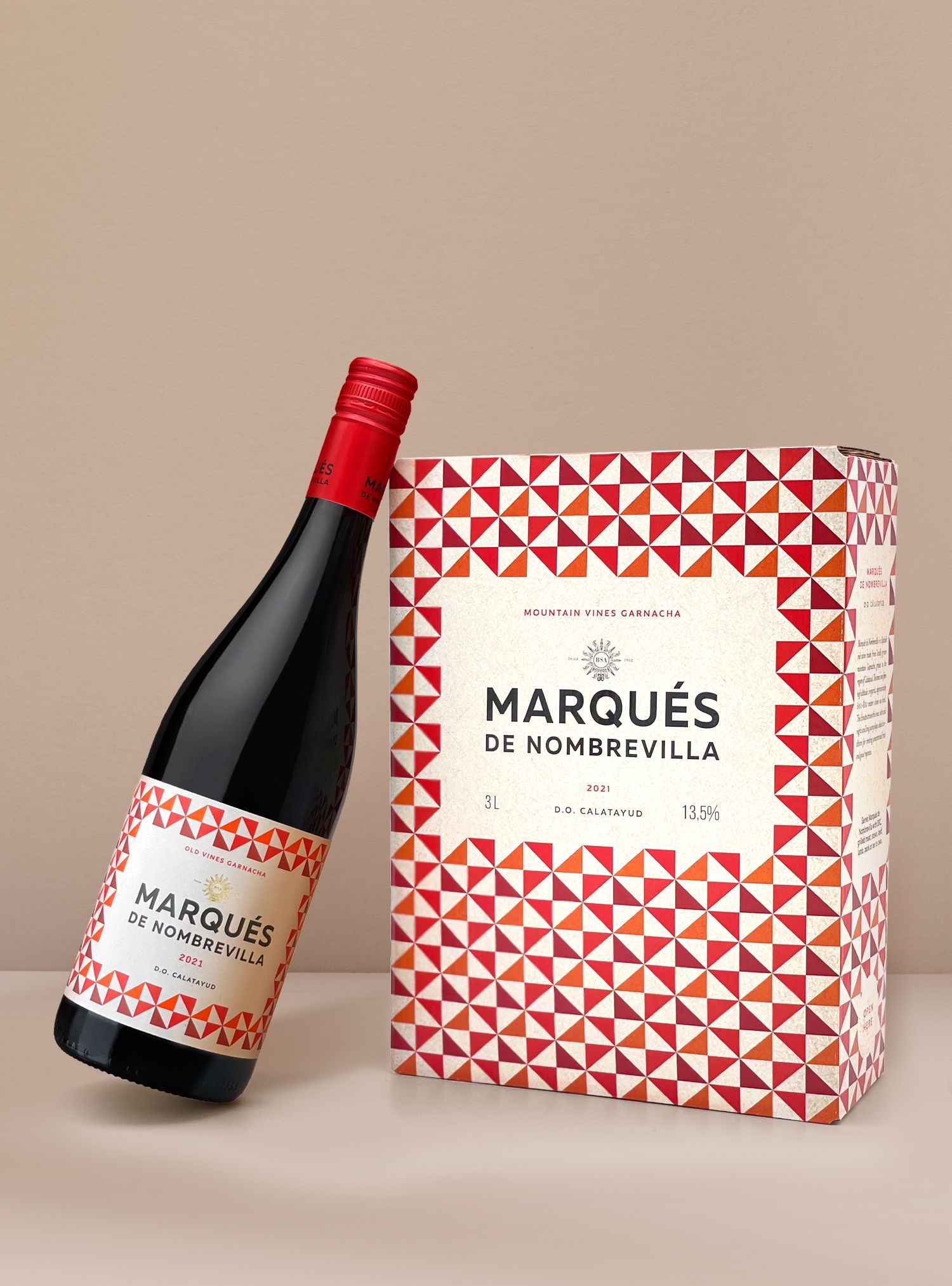Bottle of red wine and patterned box, both labeled